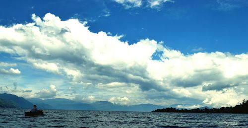 Scenic view of sea against cloudy sky