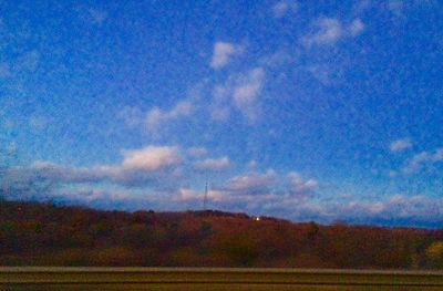 Scenic view of landscape against blue sky