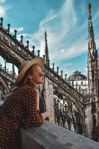 Midsection of woman in city against sky