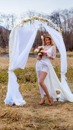 Woman with umbrella on field