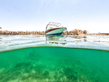 Scenic view of swimming pool by sea against clear sky