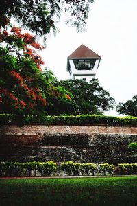 Low angle view of house and trees against sky