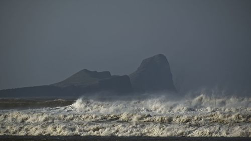 Scenic view of wild waves against clear sky