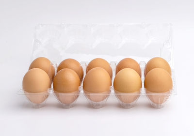 Close-up of eggs against white background