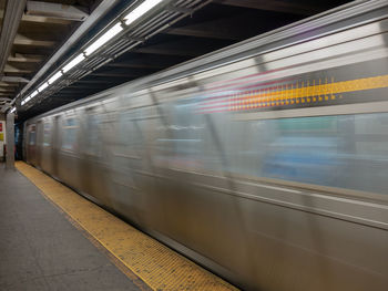 Blurred motion of train at railroad station