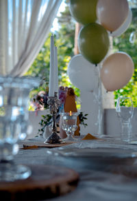 Festive table with a candle and balloons in a eco-friendly style. fashionable table setting