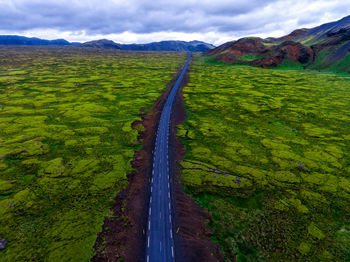 Scenic view of road on mountains against sky