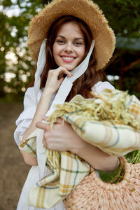 Portrait of smiling young woman wearing hat