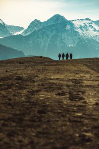 Silhouette people on mountain against sky during winter