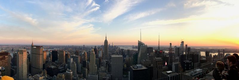 Aerial view of buildings in city during sunset