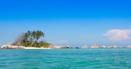 Scenic view of sea against blue sky