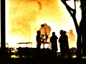 Silhouette people looking at sunset