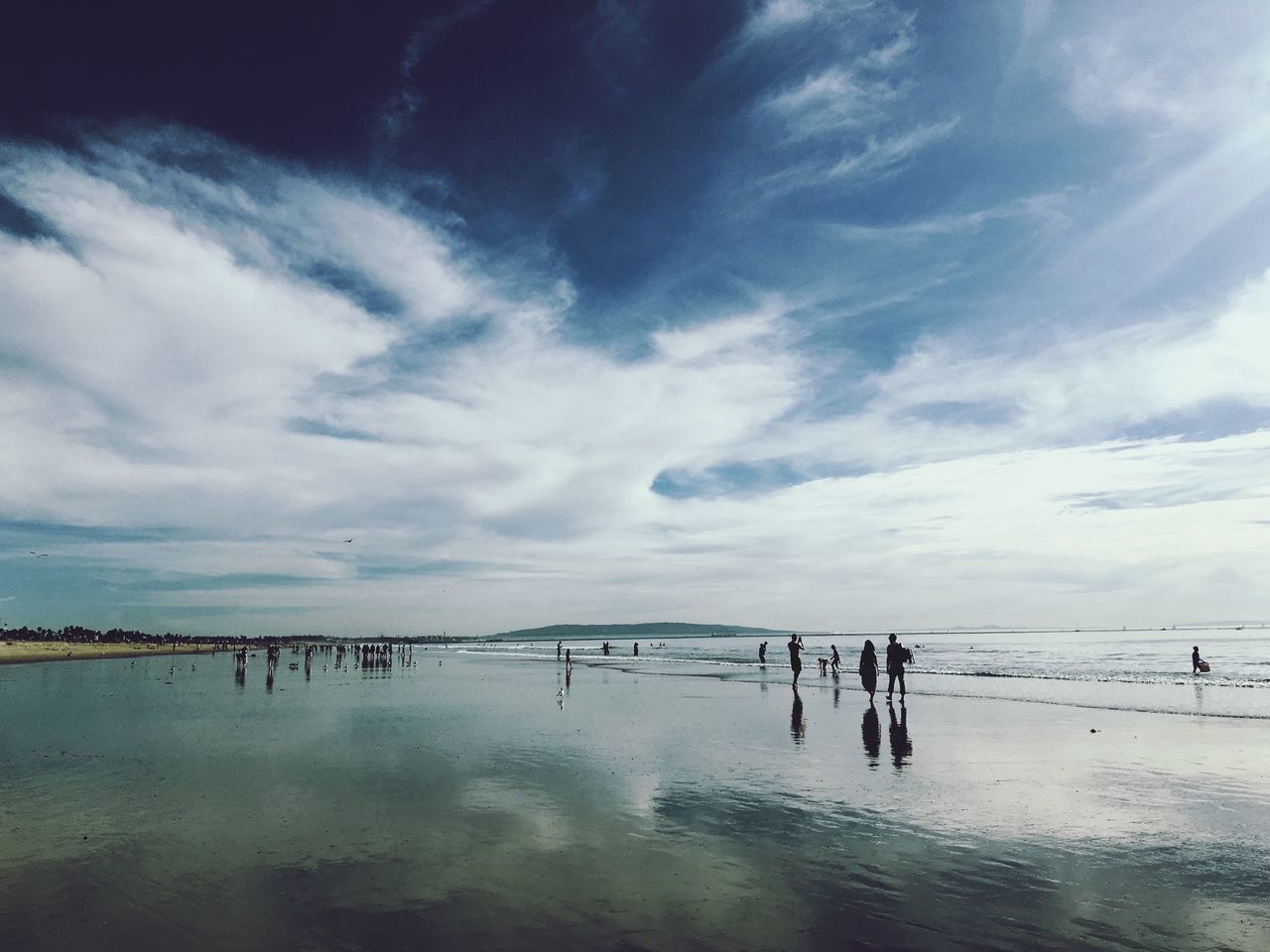 PEOPLE AT BEACH AGAINST SKY