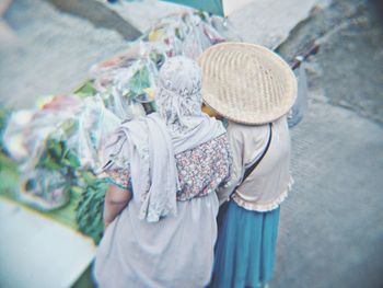 Rear view of women standing on street