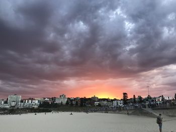 Scenic view of dramatic sky over town