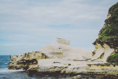 Scenic view of sea against cloudy sky