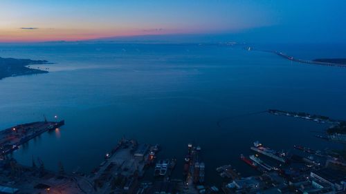 High angle view of city by sea against sky