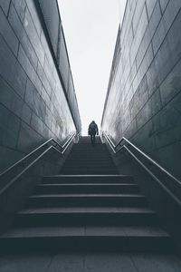 Low angle view of man walking on staircase