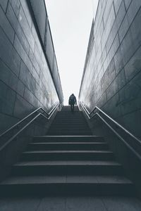 Low angle view of man walking on staircase