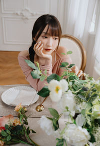 Portrait of young woman with bouquet