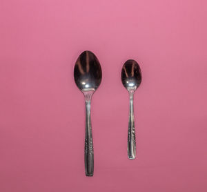 Close-up of wineglass against pink background