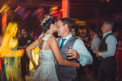 Side view of a young couple standing at night