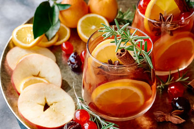 Mulled wine or christmas sangria with aromatic spices, apple, cherry and citrus fruits.