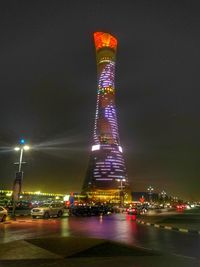 Low angle view of illuminated city lit up at night