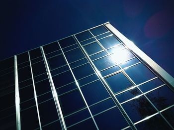 Low angle view of modern building against blue sky