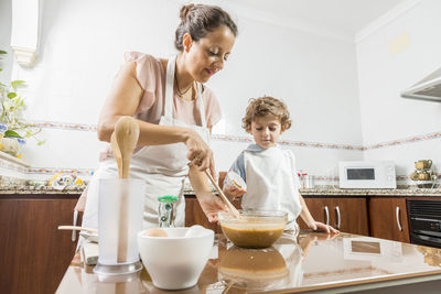 Woman and son cooking on table
