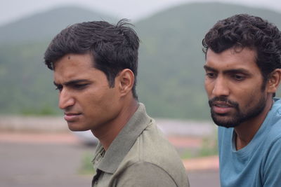 Close-up of men looking down outdoors