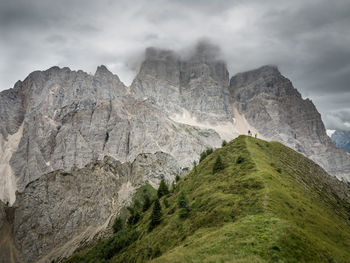 Scenic view of mountains against cloudy sky