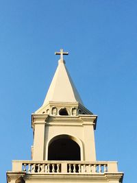 Low angle view of bell tower against blue sky