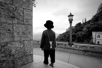 Rear view of man standing against sky