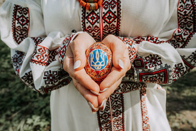 Midsection of woman holding easter egg