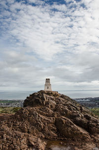 Built structure on rock against sky