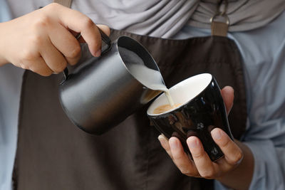 Midsection of woman holding coffee