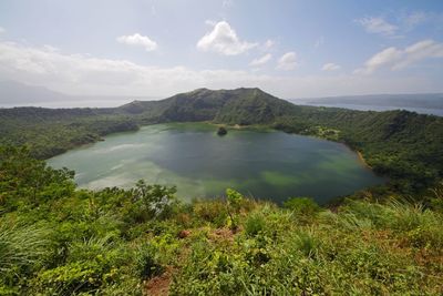 Scenic view of lake against cloudy sky