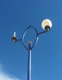 Low angle view of street light against clear blue sky