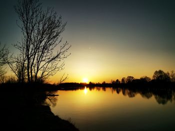 Scenic view of lake against sky during sunset