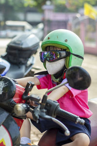 Girl riding toy motorcycle