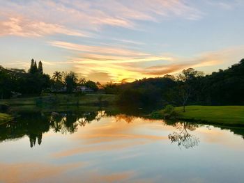 Scenic view of lake against sky at sunset