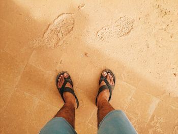 Low section of man standing on footpath