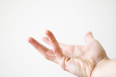 Close-up of hand over white background