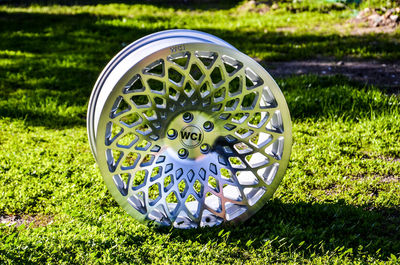 Close-up of bicycle wheel on field