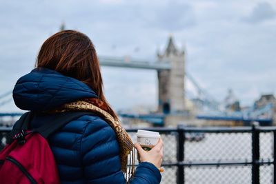 Rear view of woman drinking coffee in london 