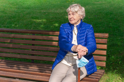 Man sitting on bench in park