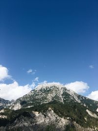 Scenic view of mountain against blue sky