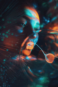 Digital composite image of woman and plasma ball with fiber optics