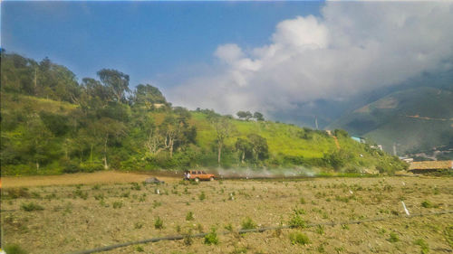 Scenic view of green landscape against sky